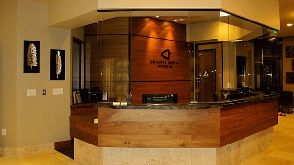 Granite Pointe Eye Care reception area in Roseville, CA featuring modern wood-front desk and welcoming optometry clinic interior